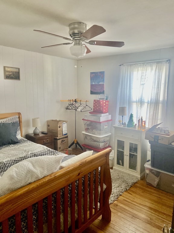44 Brewster Road Waltham, MA 02451 - Photo 17 of 31 a bedroom with a bed a chandelier and dresser