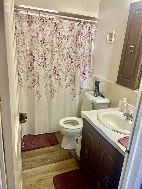 44 Brewster Road Waltham, MA 02451 - Photo 22 of 31 a bathroom with a granite countertop sink toilet and shower