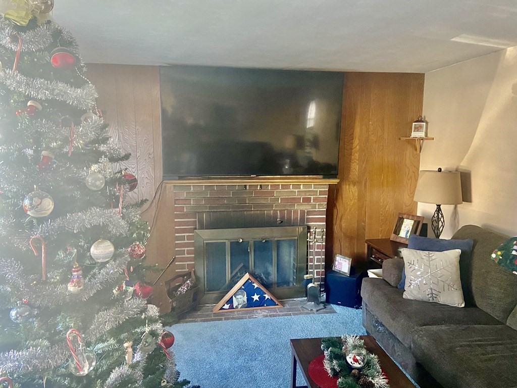 44 Brewster Road Waltham, MA 02451 - Photo 28 of 31 a living room with furniture and a fireplace
