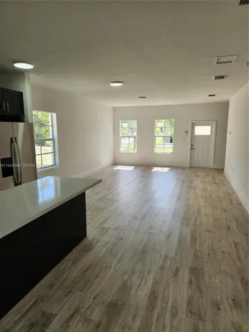 a view of wooden floor and windows in a room