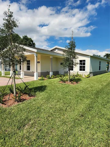 a front view of house with yard and green space