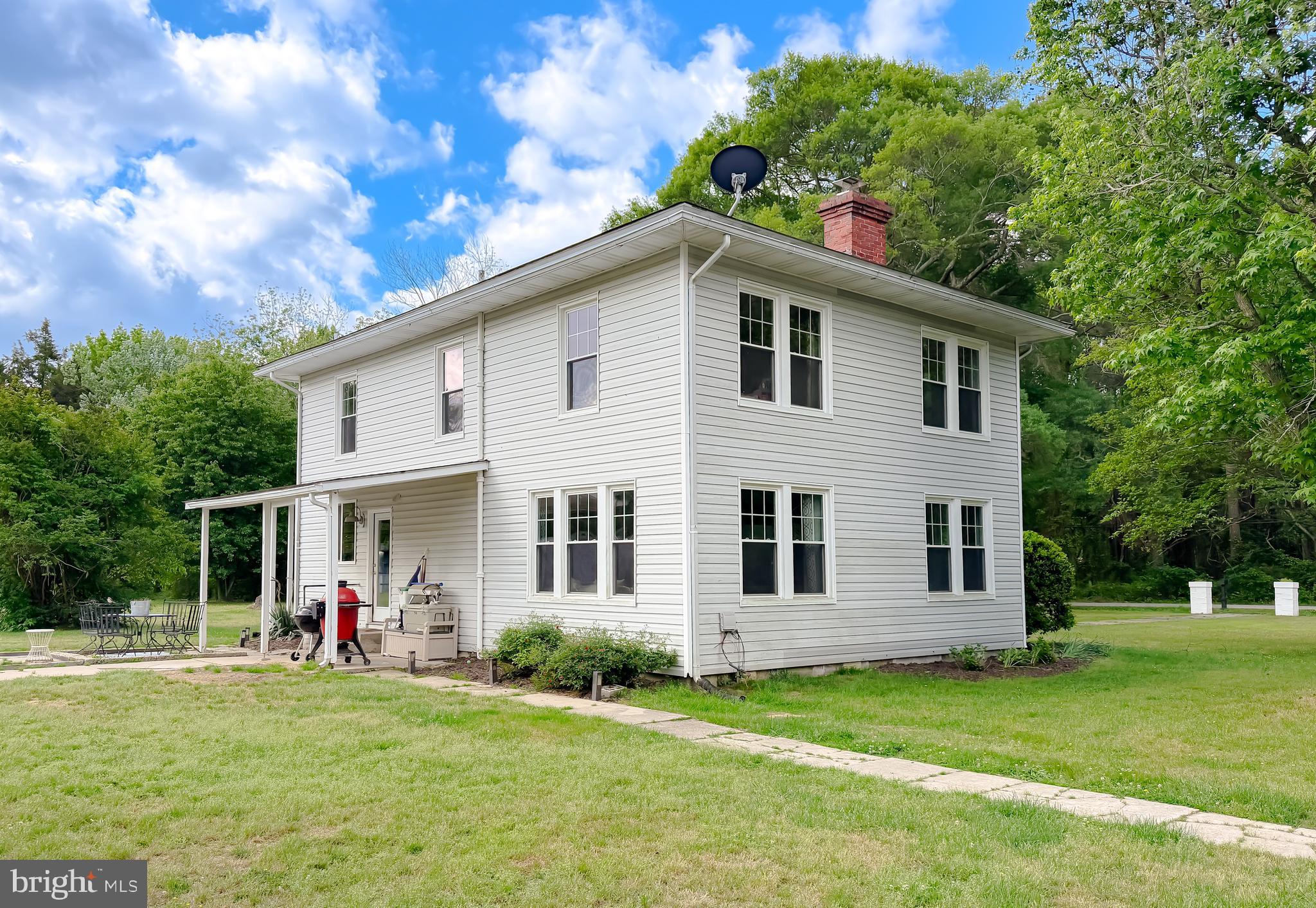 16146 Thomas Road Piney Point, MD 20674 - Photo 39 of 57 a front view of a house with a garden