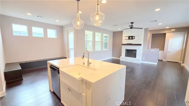 a view of kitchen with sink and wooden floor