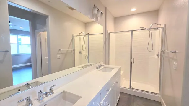 a spacious bathroom with a shower and a sink