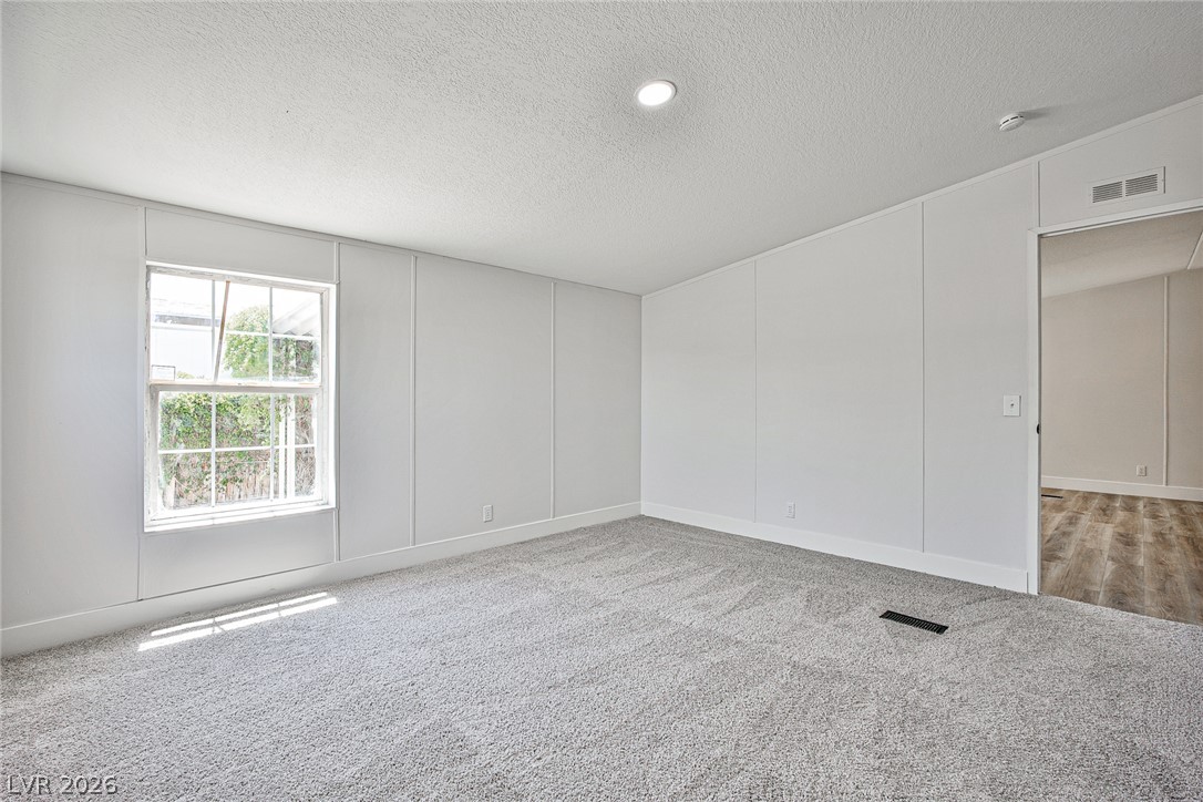 273 Aztec Lane Henderson, NV 89015 - Photo 16 of 28 Sun-filled room with plush carpet, ideal for peaceful relaxation or a home office.