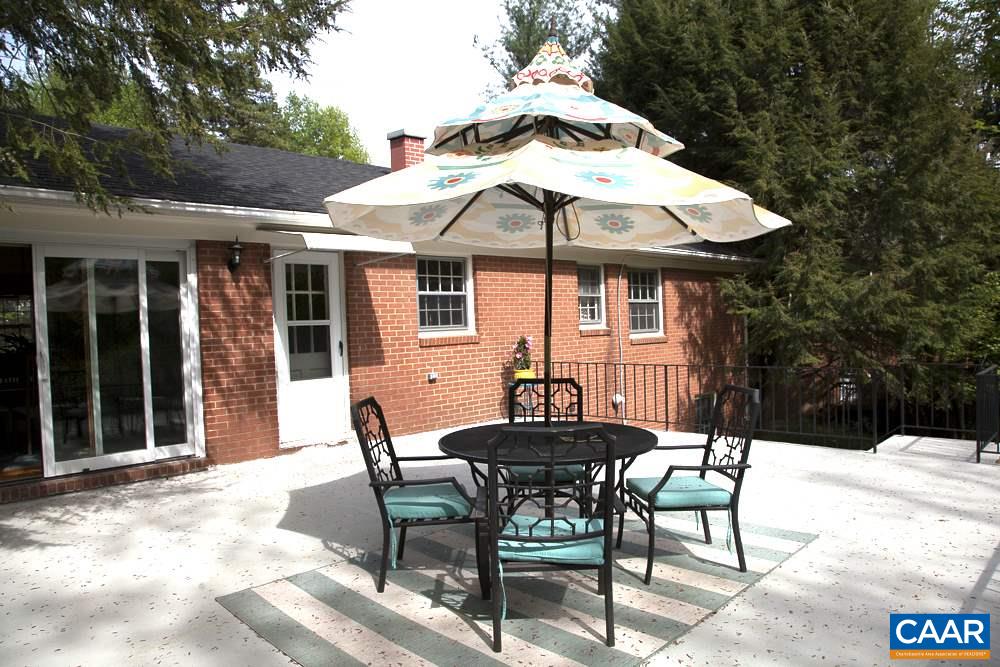 2405 Barracks Road Charlottesville, VA 22901 - Photo 11 of 48 a patio with a table and chairs under an umbrella
