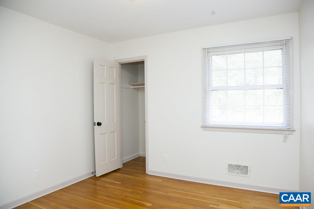 2405 Barracks Road Charlottesville, VA 22901 - Photo 37 of 48 an empty room with wooden floor and windows