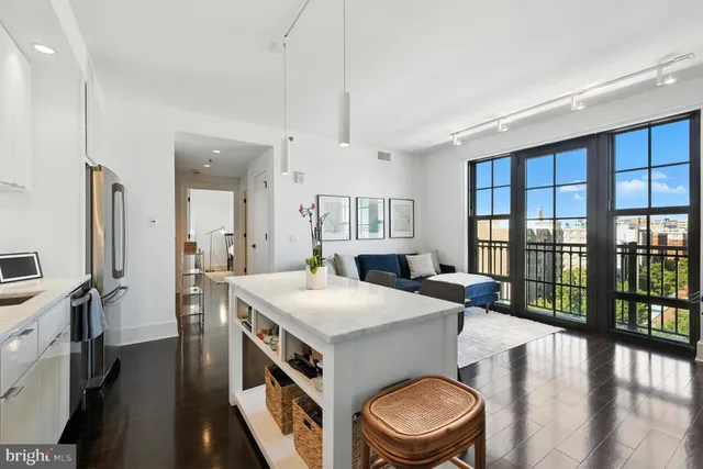 a kitchen that has a sink a stove and a refrigerator