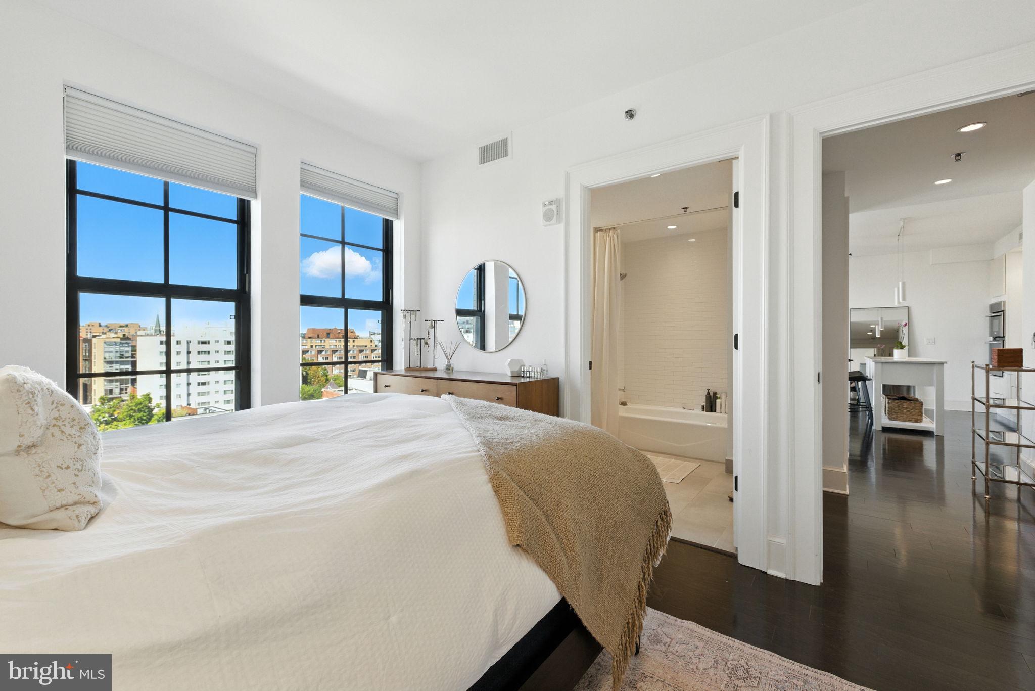 1011 M Street Northwest, Unit 901 Washington, DC 20001 - Photo 13 of 26 a bedroom with a bed and a large window
