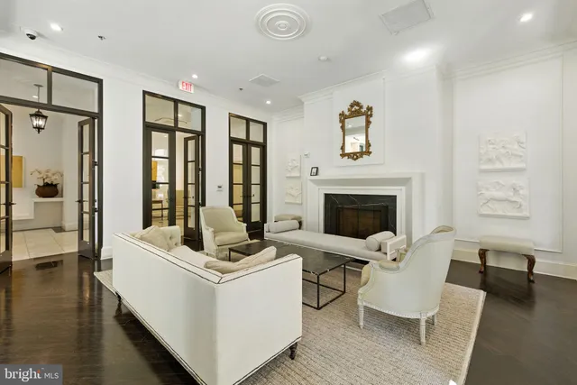 a living room with furniture a fireplace and a table