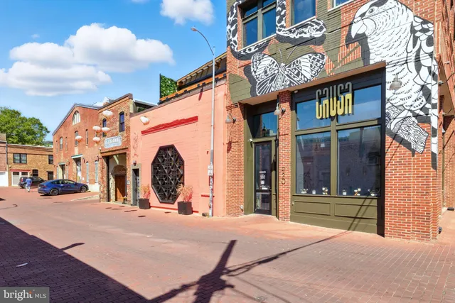 a view of a building with entryway and a front door
