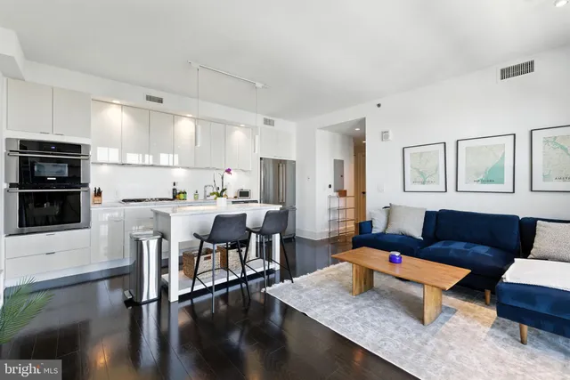 a living room with furniture and kitchen view