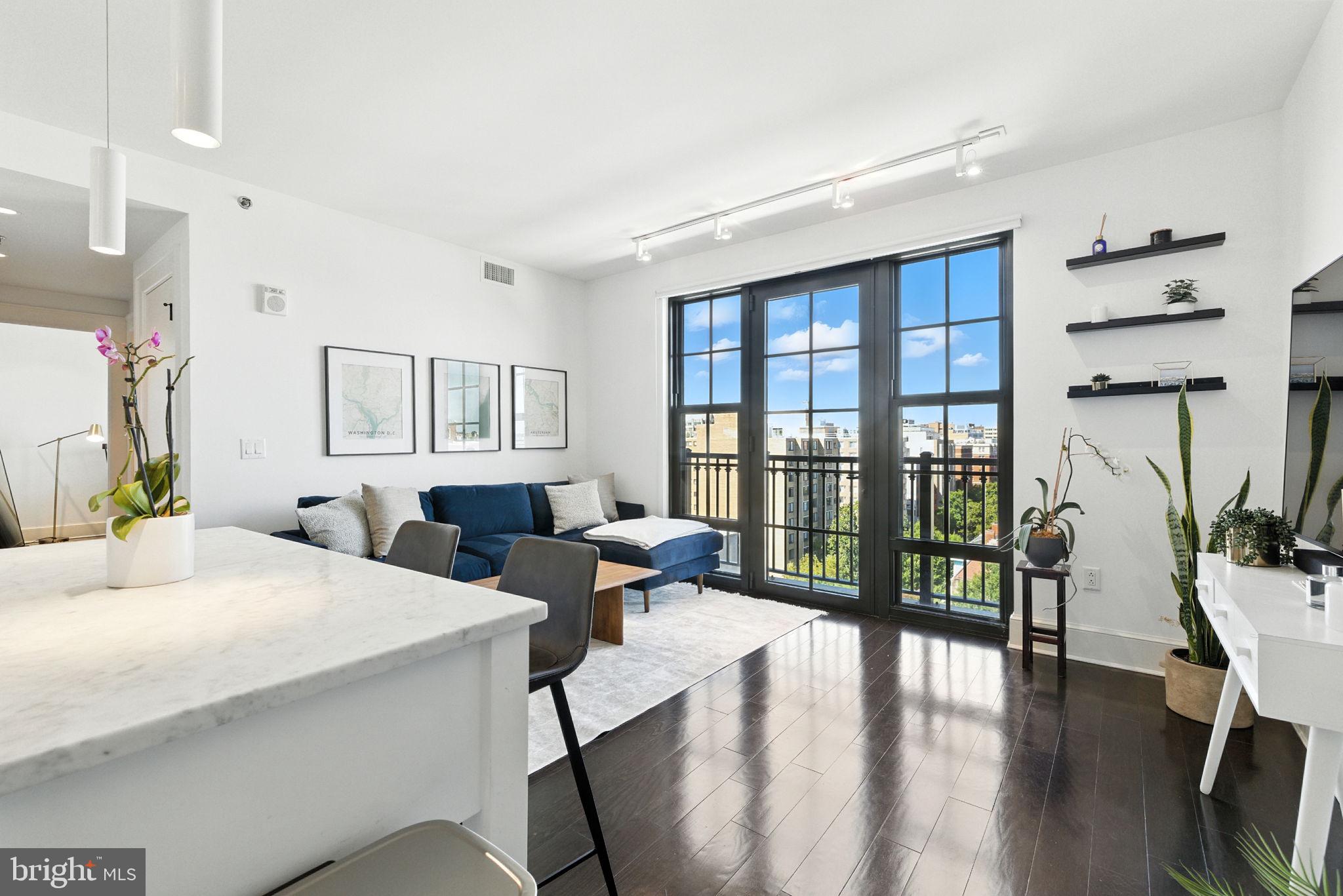 1011 M Street Northwest, Unit 901 Washington, DC 20001 - Photo 8 of 26 a large bedroom with wooden floor and windows