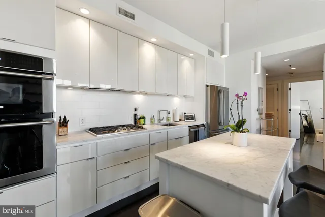 a kitchen with a sink a stove and cabinets