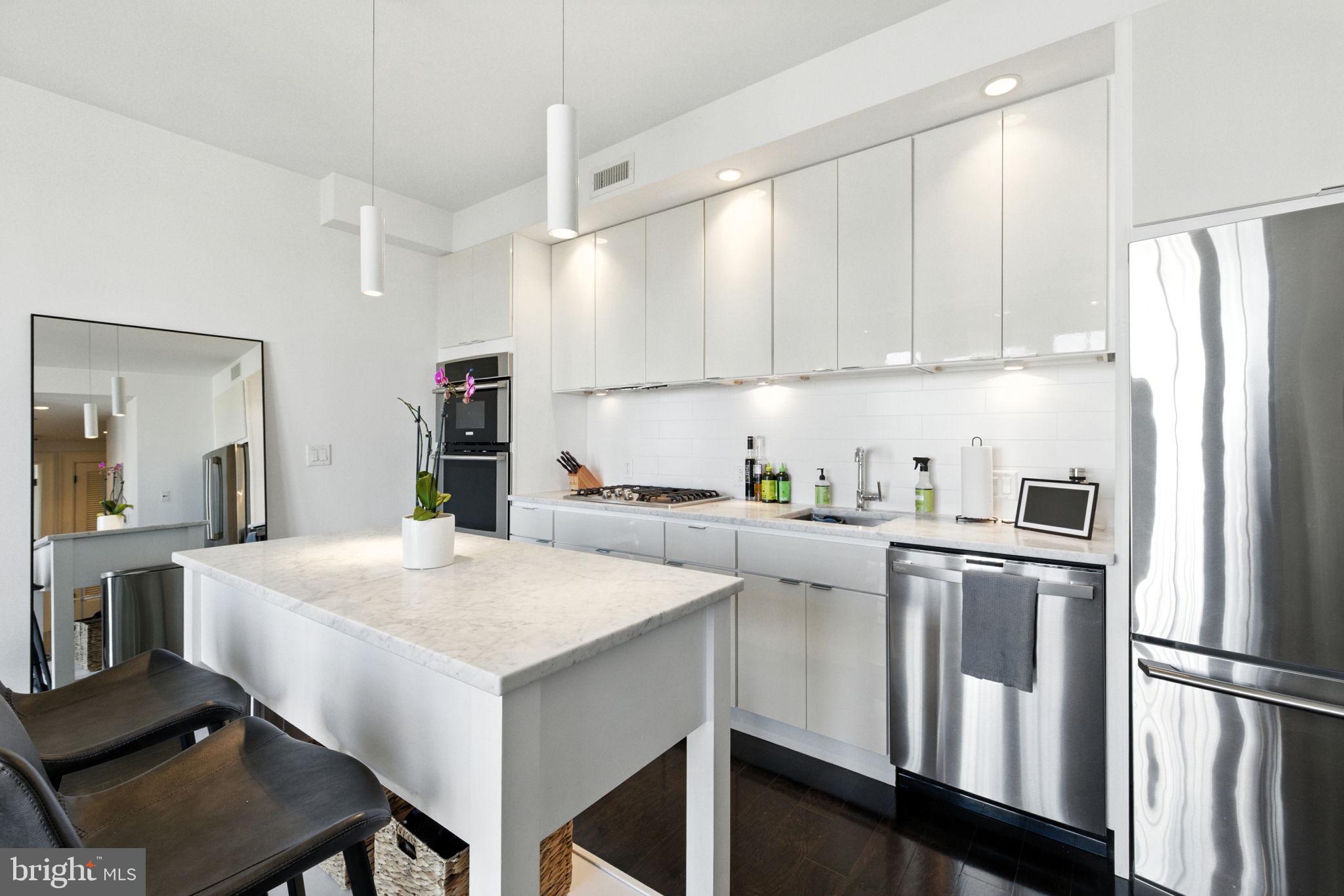 1011 M Street Northwest, Unit 901 Washington, DC 20001 - Photo 10 of 26 a kitchen with white cabinets and refrigerator