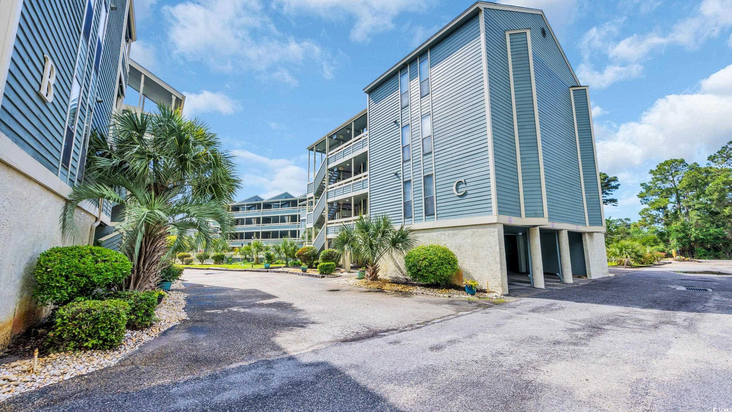 1101 Possum Trot Road, Unit C203 North Myrtle Beach, SC 29582 - Photo 5 of 29 View of property featuring driveway