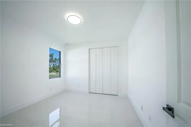 a view of kitchen with kitchen island a sink stainless steel appliances and cabinets