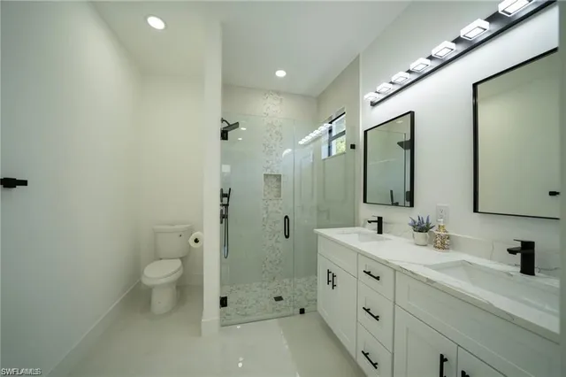 a bathroom with a double vanity sink and mirror