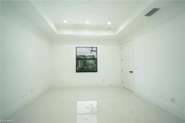 a spacious bathroom with a double vanity sink toilet mirror and a shower