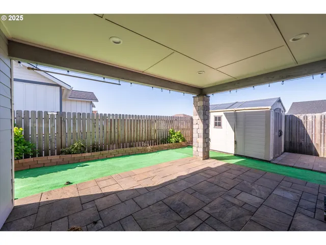 a view of a backyard with wooden fence