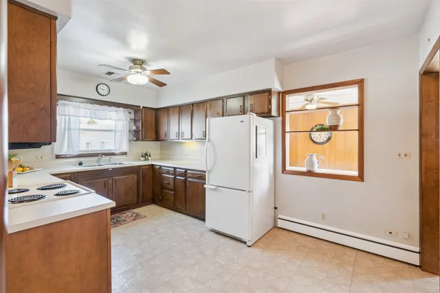 a kitchen with stainless steel appliances cabinets a sink and a window