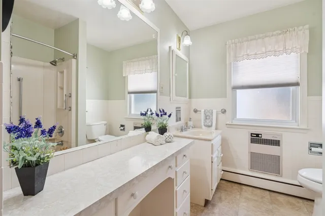 a bathroom with a sink a vanity and a window