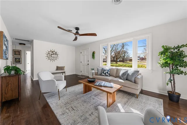 a living room with furniture a large window with wooden floor