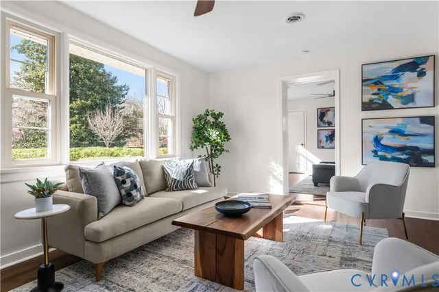 a large white kitchen with cabinets and wooden floor