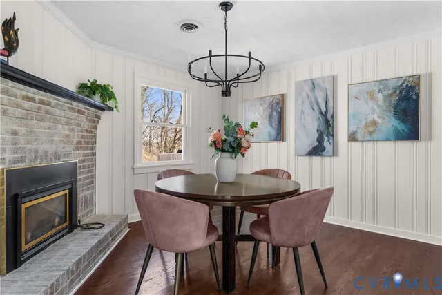 a view of a dining room with furniture wooden floor and a chandelier