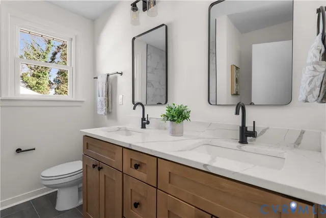 a view of a room with wooden floor and a ceiling fan
