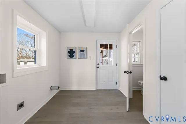 a bathroom with a granite countertop toilet sink and mirror