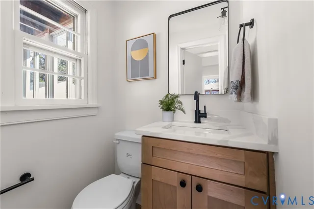 a view of a dining room with furniture wooden floor and a potted plant