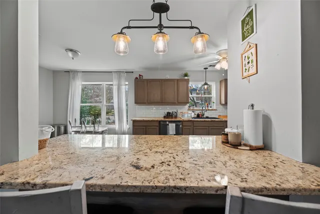 a kitchen with stainless steel appliances kitchen island granite countertop a sink stove and granite counter top