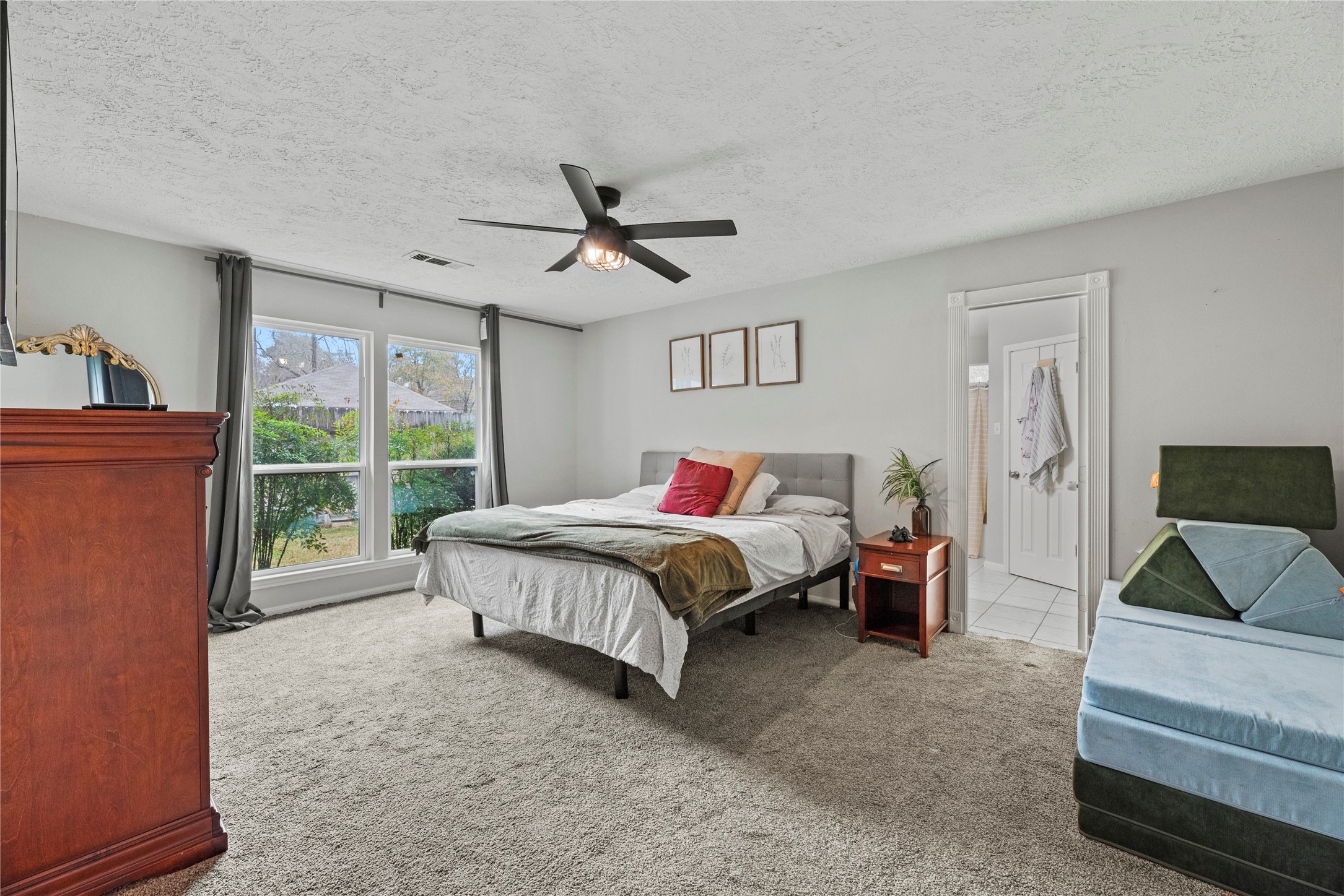 24902 Butterwick Drive Spring, TX 77389 - Photo 6 of 24 a spacious bedroom with a bed a window and a fireplace