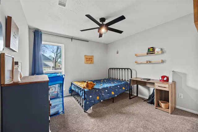 a bedroom with a bed and a desk