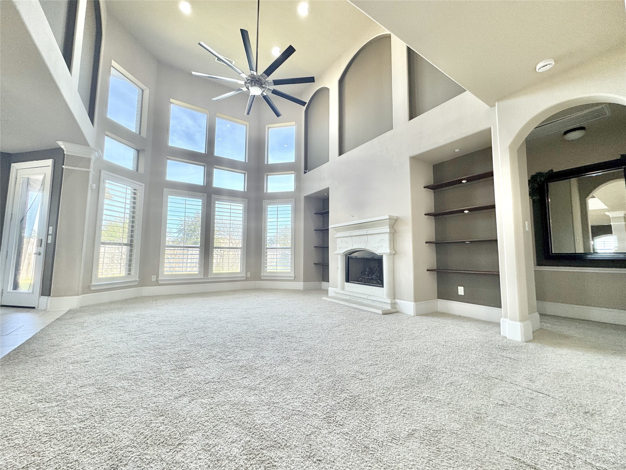 8447 Roland Canyon Drive Cypress, TX 77433 - Photo 14 of 48 an empty room with windows and fireplace