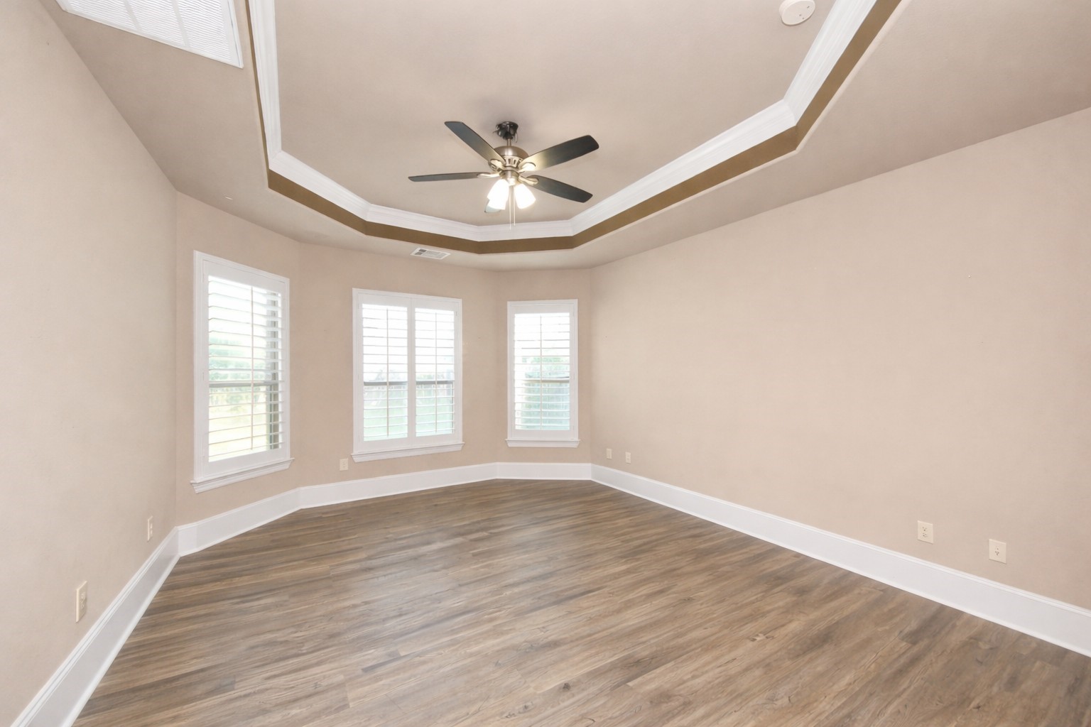 8447 Roland Canyon Drive Cypress, TX 77433 - Photo 20 of 48 an empty room with wooden floor fan and windows