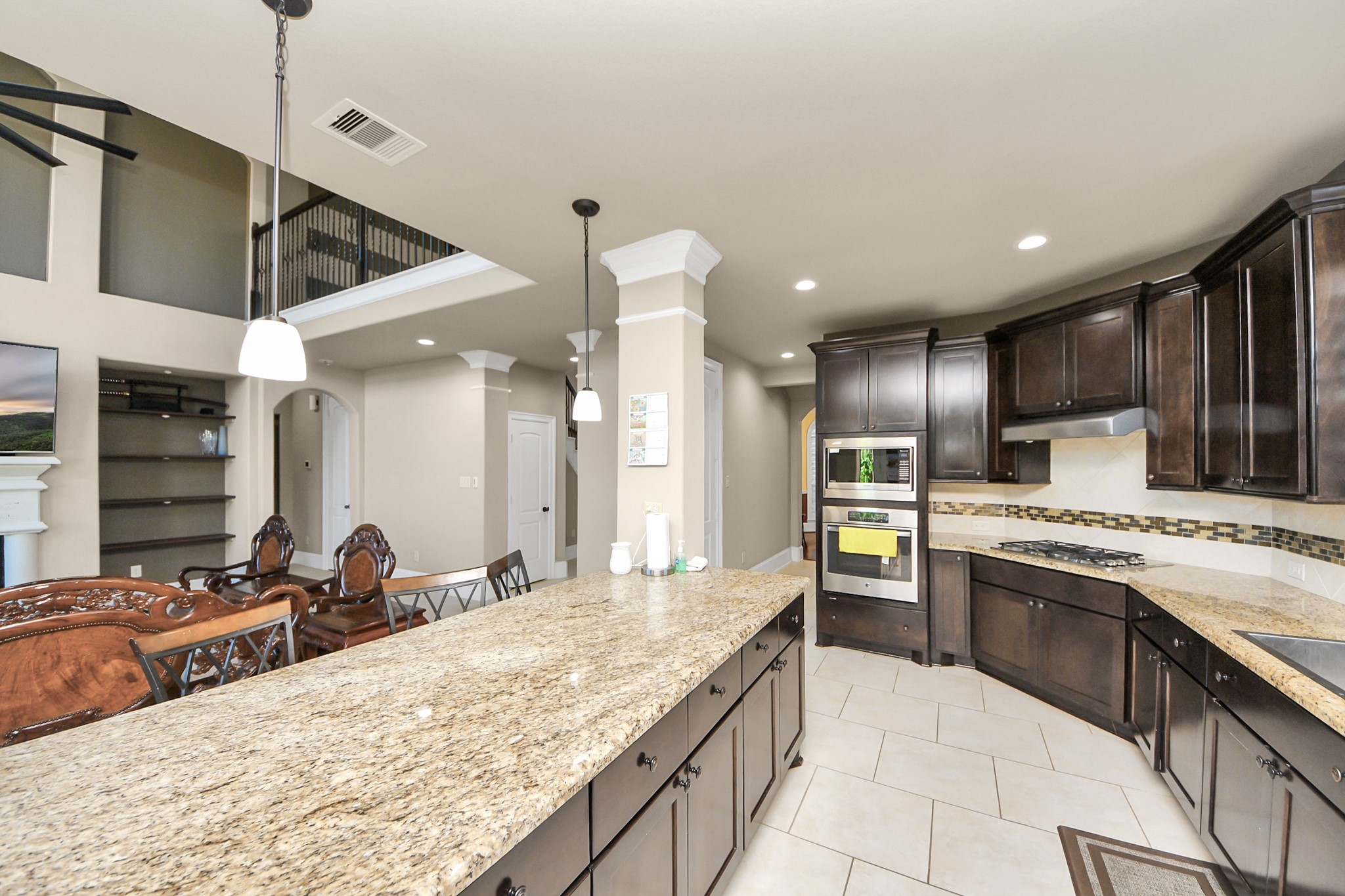 8447 Roland Canyon Drive Cypress, TX 77433 - Photo 22 of 48 a large kitchen with granite countertop a sink and a refrigerator