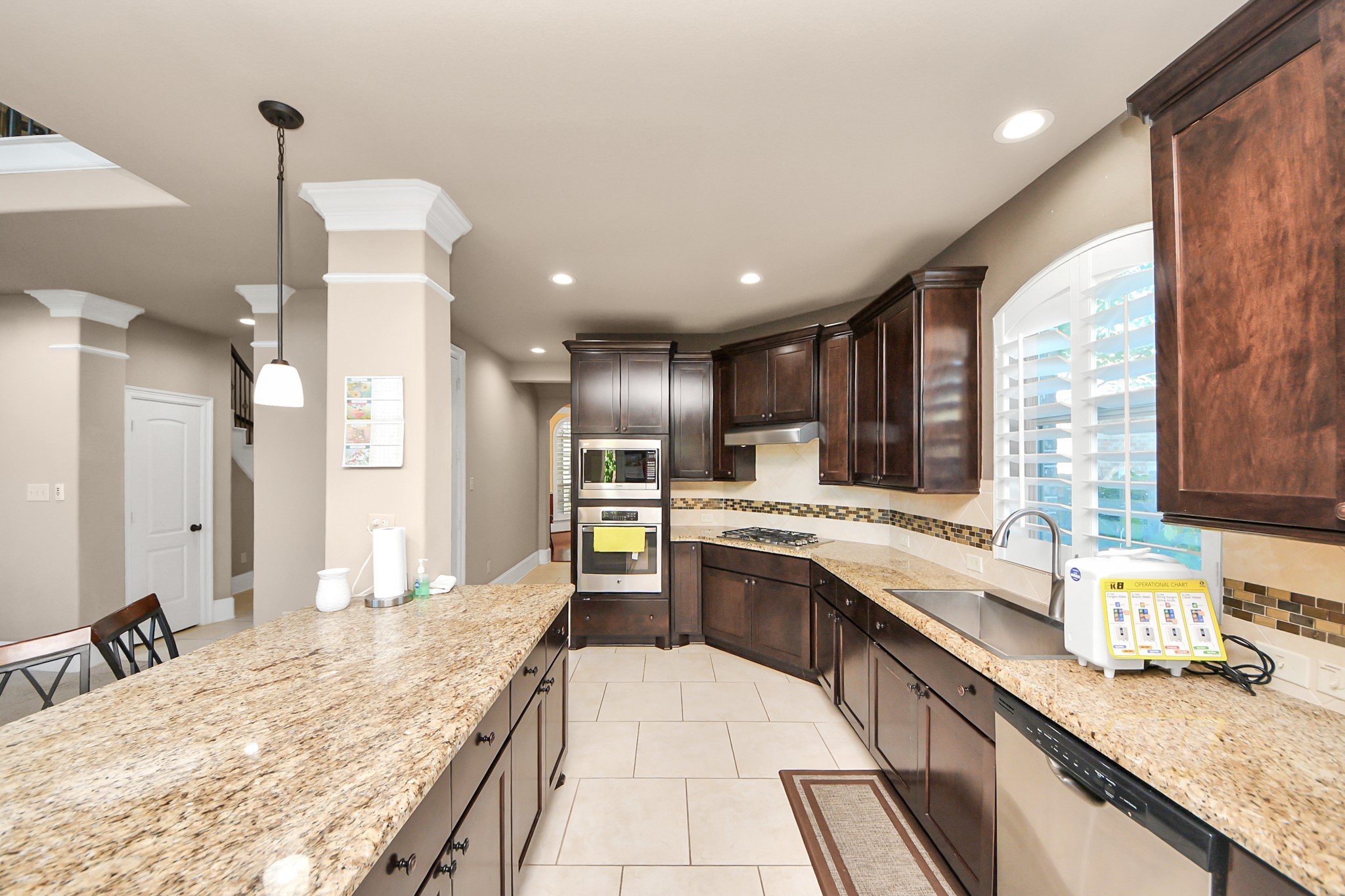 8447 Roland Canyon Drive Cypress, TX 77433 - Photo 23 of 48 a large kitchen with granite countertop a large counter top appliances and cabinets