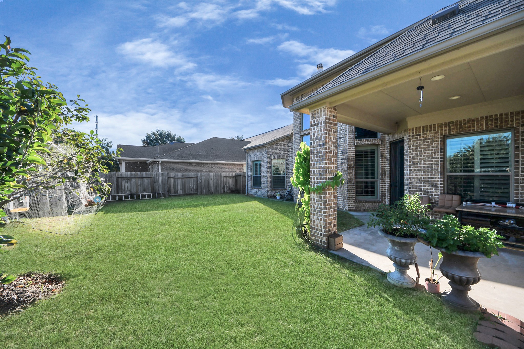 8447 Roland Canyon Drive Cypress, TX 77433 - Photo 43 of 48 a front view of a house with a garden and plants