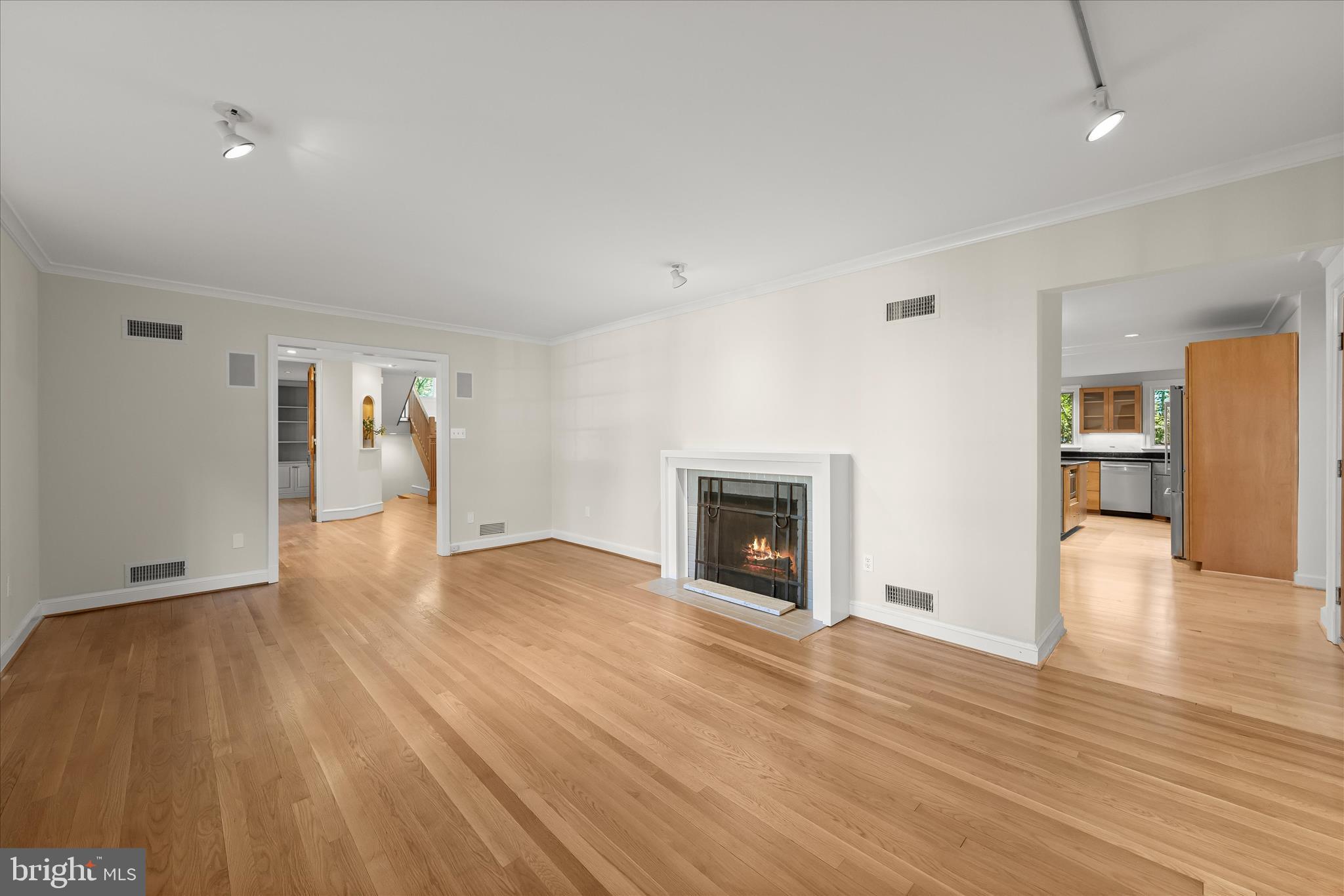 5104 Scarsdale Road Bethesda, MD 20816 - Photo 11 of 68 a view of empty room with a fireplace and wooden floor