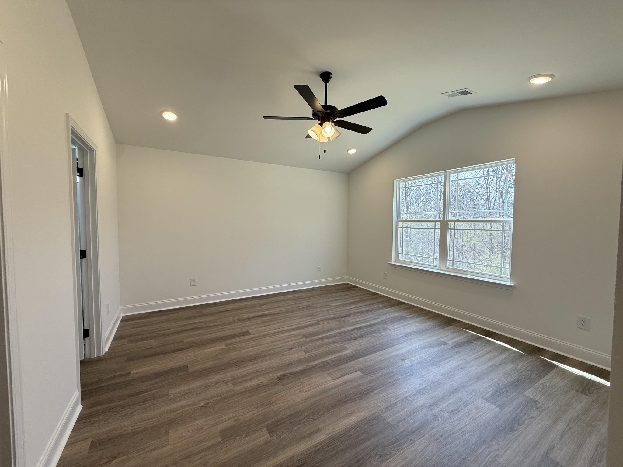 508 Mandalorian Way Dickson, TN 37055 - Photo 3 of 8 a view of an empty room with wooden floor and a window