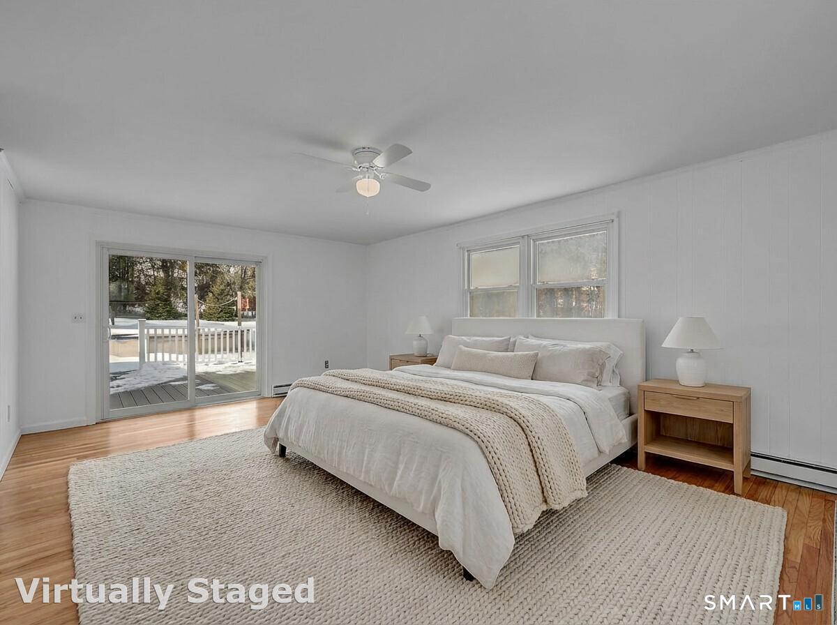3 Grand Place Newtown, CT 06470 - Photo 16 of 40 The primary bedroom is adorned with hardwood floors, ample closet space and sliding glass doors that lead directly to the oversized deck.