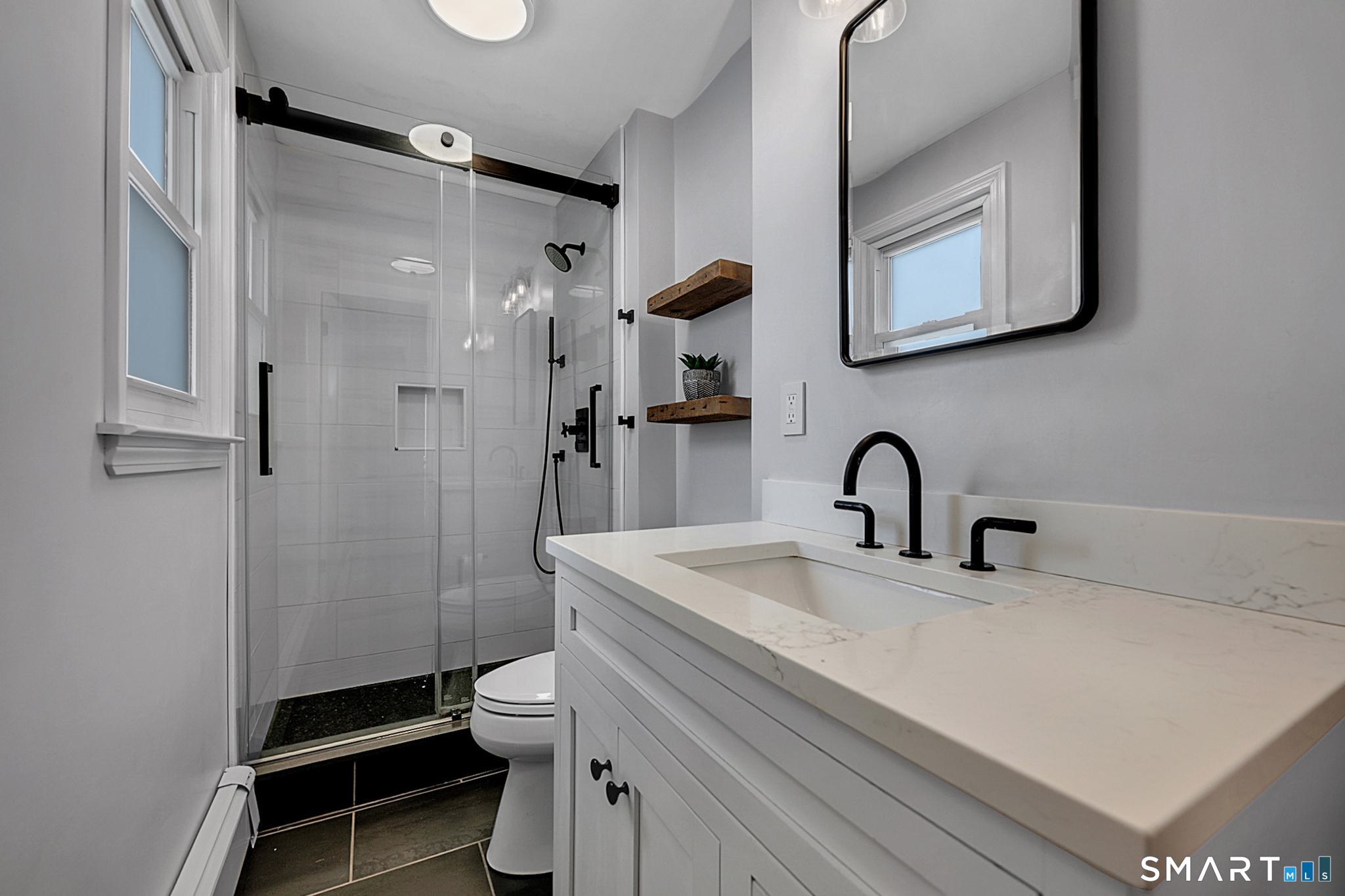 3 Grand Place Newtown, CT 06470 - Photo 17 of 40 The beautifully updated modern bathroom was designed with stylish finishes and convenient amenities.