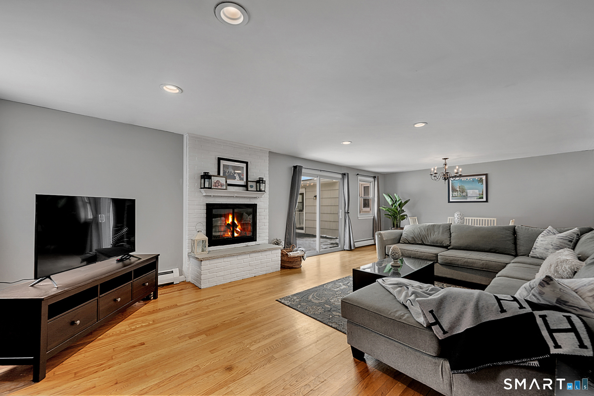 3 Grand Place Newtown, CT 06470 - Photo 7 of 40 Gleaming hardwood floors add warmth while a charming wood-burning fireplace serves as the focal point for the room.