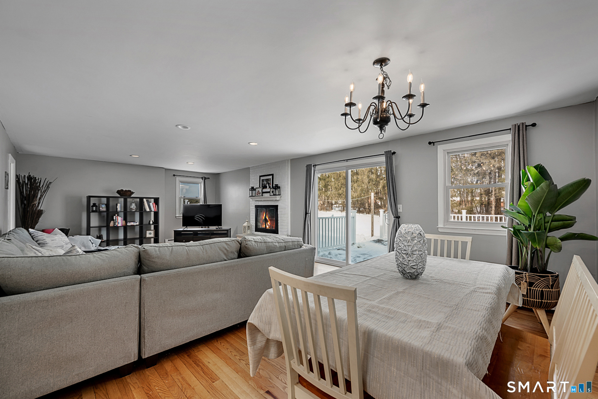 3 Grand Place Newtown, CT 06470 - Photo 8 of 40 The expansive living room flows into the dining area, creating an inviting atmosphere for entertaining. The sliding glass doors lead to an oversized deck bringing the outdoors in.