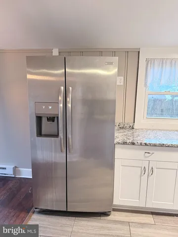 a bathroom with a granite countertop shower a sink and a mirror