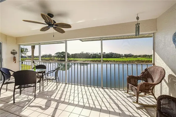 a view of a chairs and table in the balcony