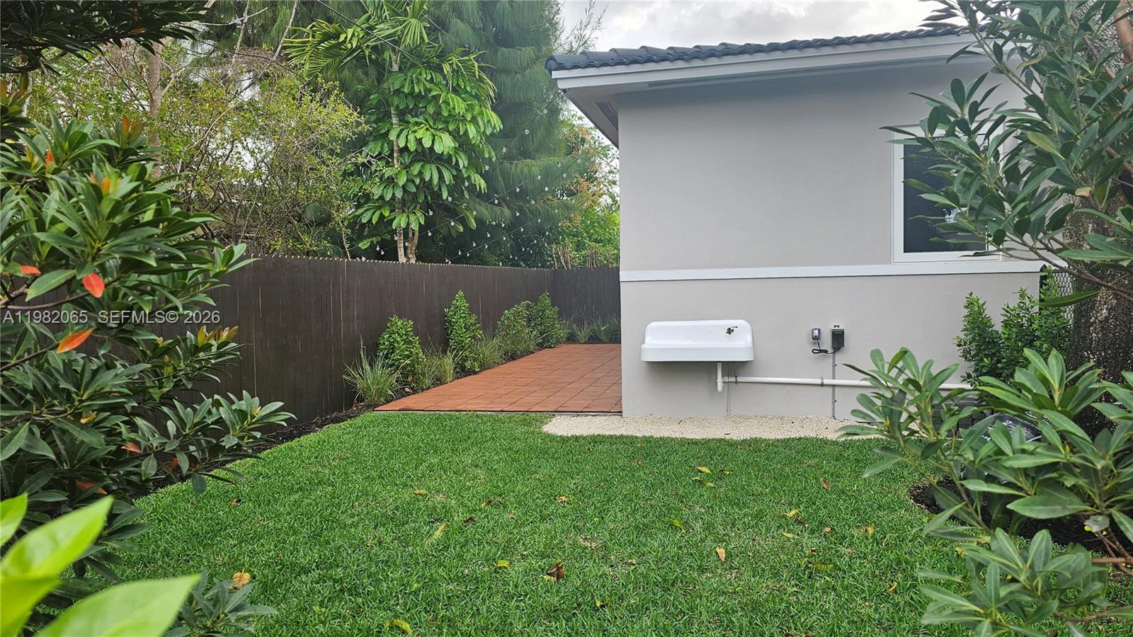 2365 Southwest 21st Avenue Miami, FL 33145 - Photo 14 of 56 a view of a backyard with plants and a patio