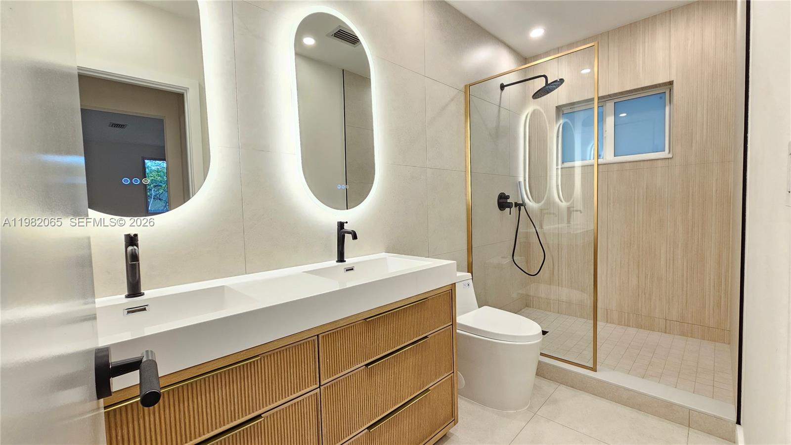2365 Southwest 21st Avenue Miami, FL 33145 - Photo 41 of 56 a bathroom with a double vanity sink toilet and shower